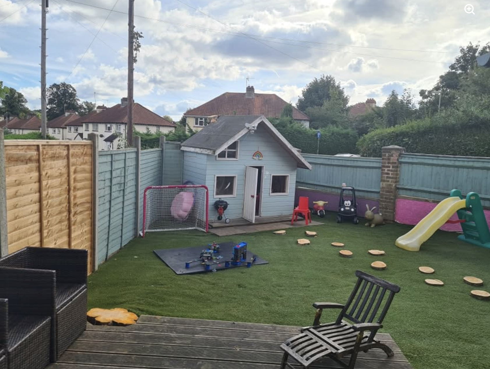 The purpose built garden, with a playhouse, slide and stepping stones